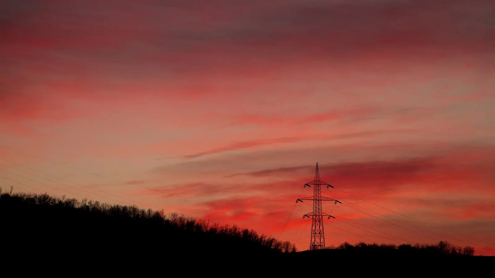 A horizon line with three diverging lights over a dark data-center landscape