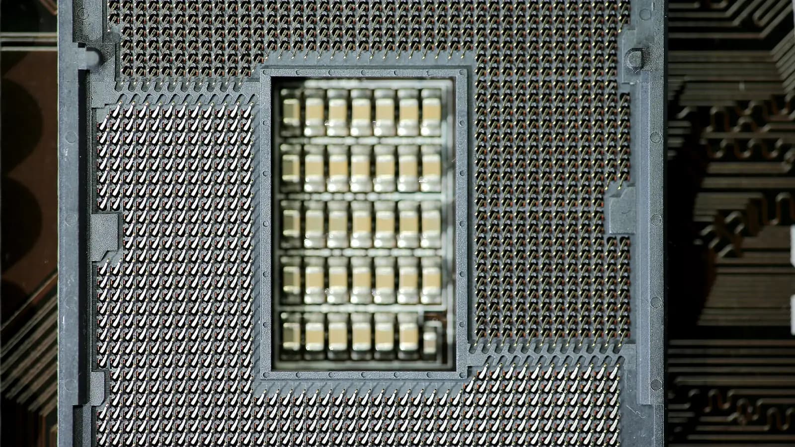 A single GPU card balanced against a stack of coins on a dark surface
