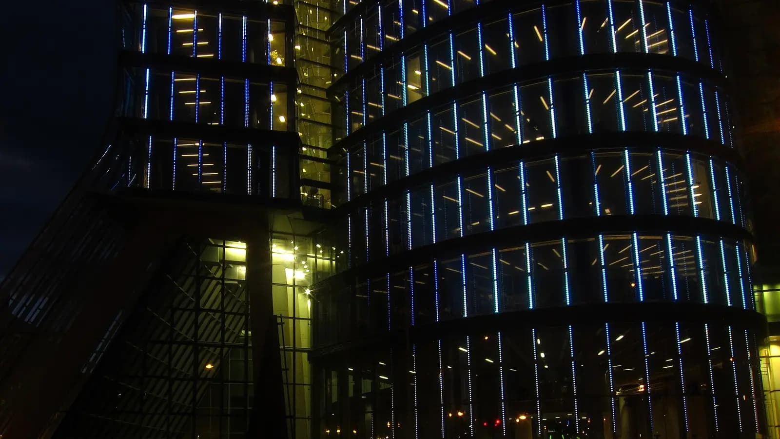 A bar chart silhouette made of office-building windows, one column glowing red