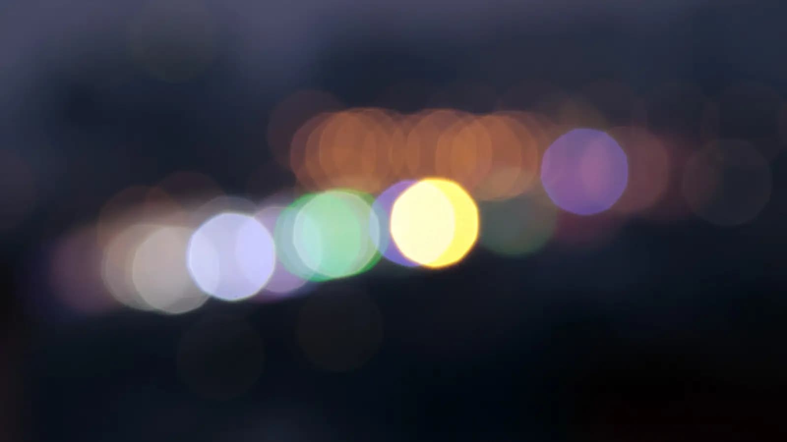 Four abstract glowing nodes of different sizes connected by thin lines on a dark field