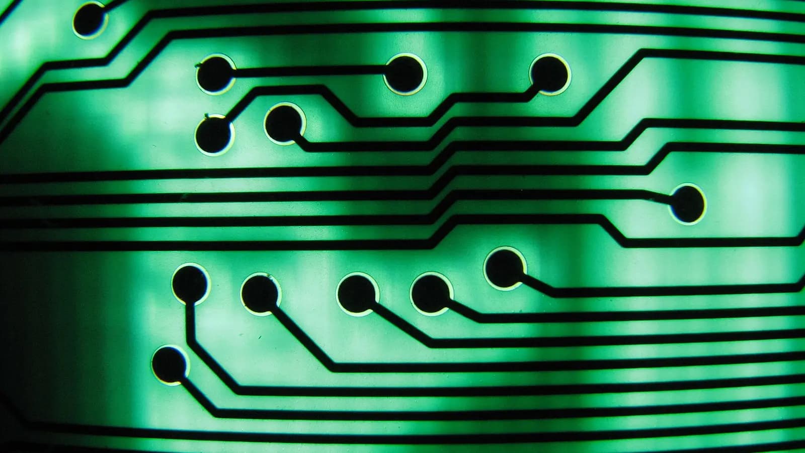 A laptop-sized silicon die glowing with a red core, surrounded by faint memory modules